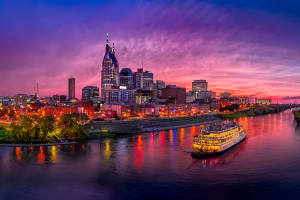 Tennessee Nashville skyline in evening with riverboats